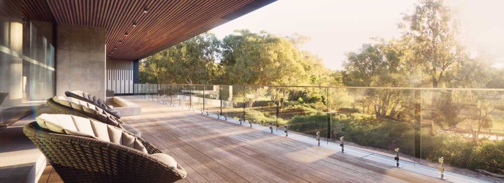 Balcony made of composite decking outside of an Australian home overlooking a beautiful garden